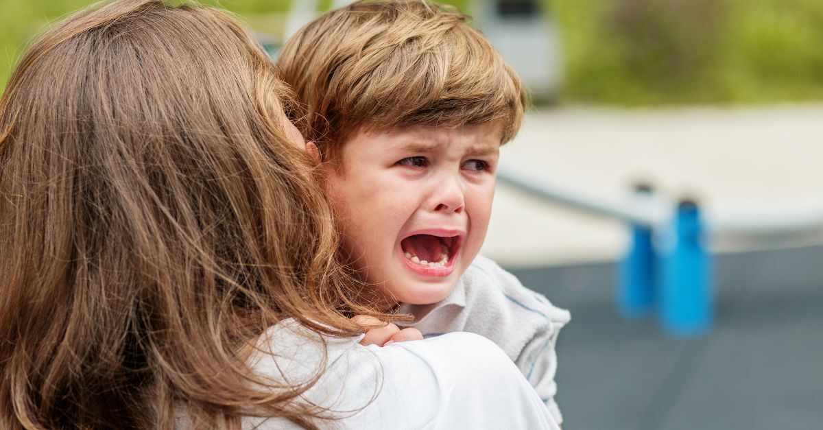 Educator comforting child who is crying